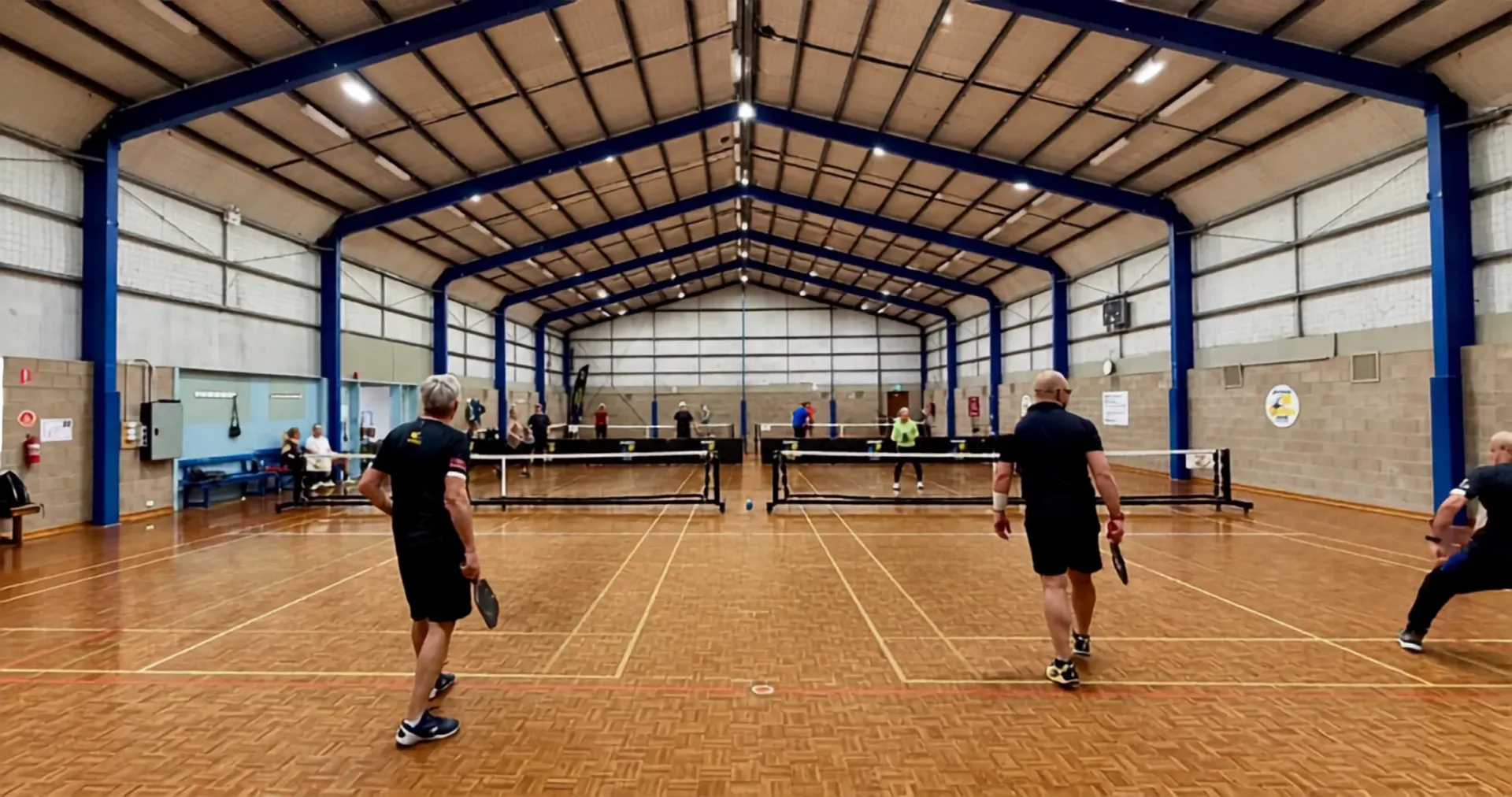 Players enjoying pickleball across Bayside's indoor courts